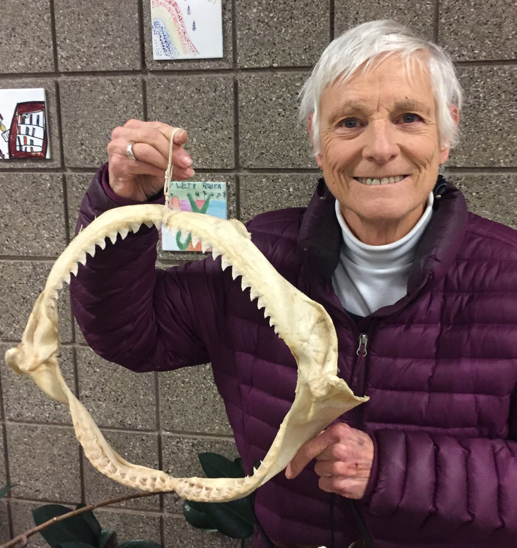 Woman holding shark jaw